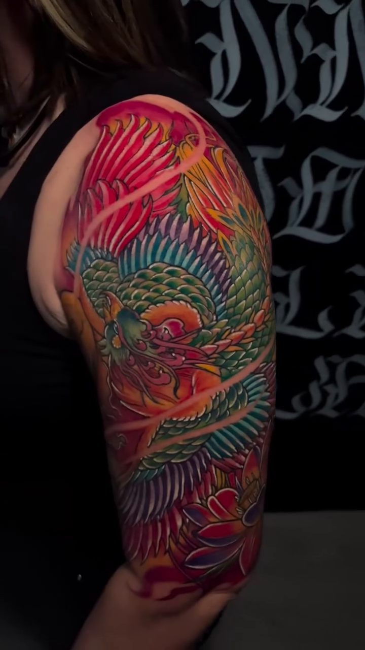 Koi fish and dragon tattoo watercolor tattoo on the upper arm by Brian Cruz Garcia