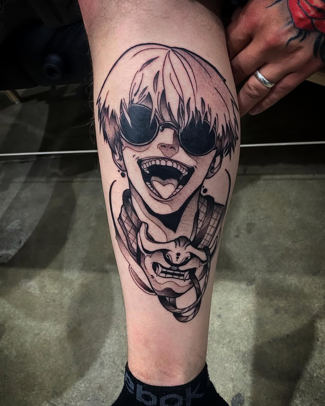 Character with mask anime tattoo on the thigh by Cody Wolfe