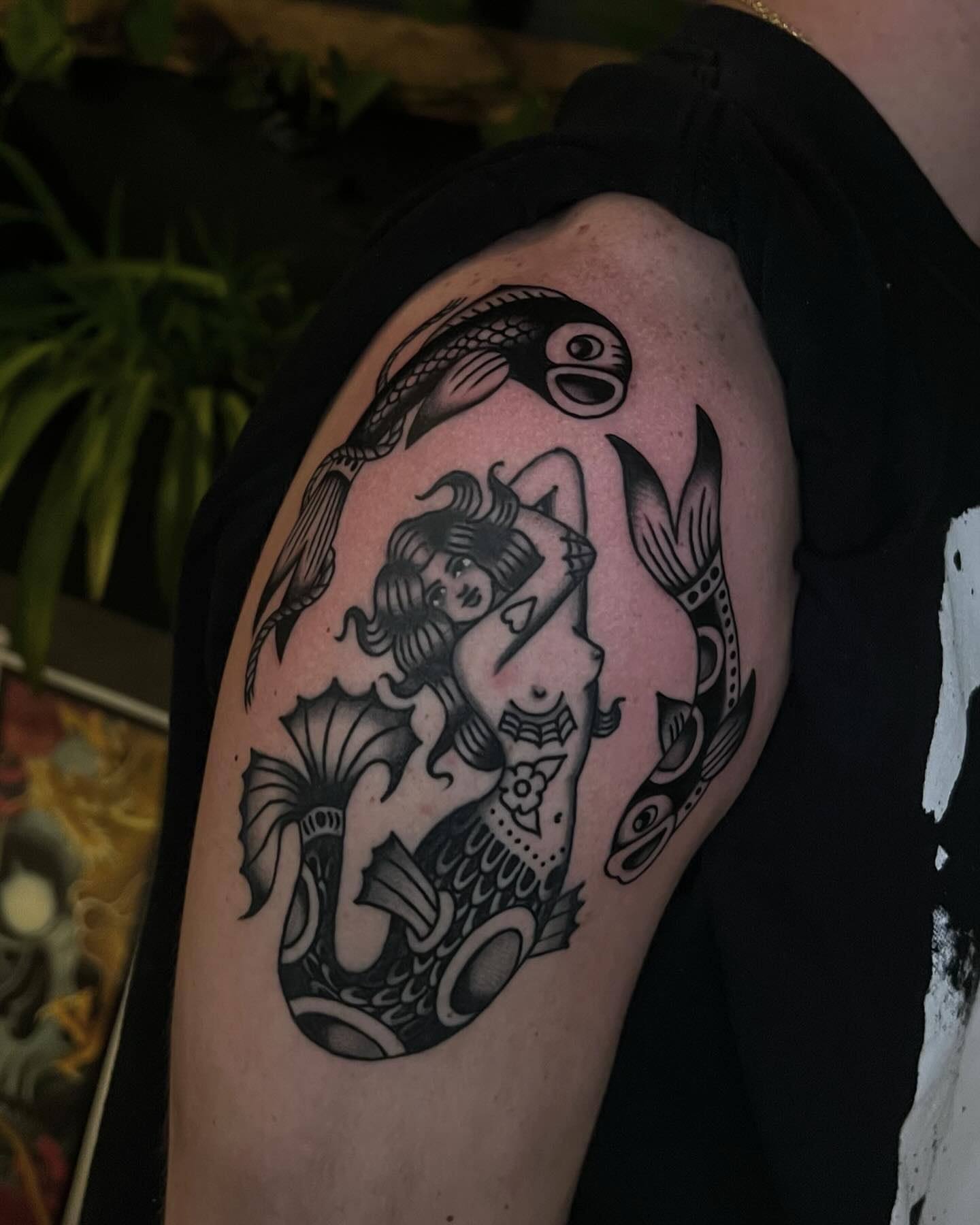 Mermaid and fish black and grey tattoo on the shoulder by Syd Sayyah