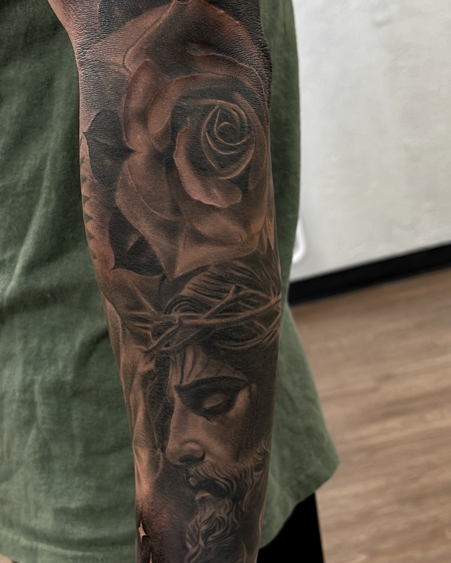 Religious figure and crown of thorns realism tattoo on the forearm by Andy