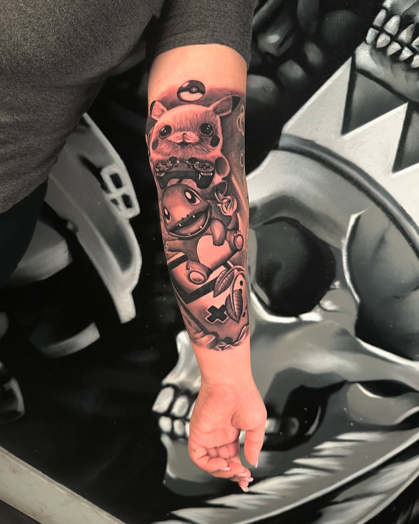 Pokemon characters black and grey tattoo on the forearm by Travis