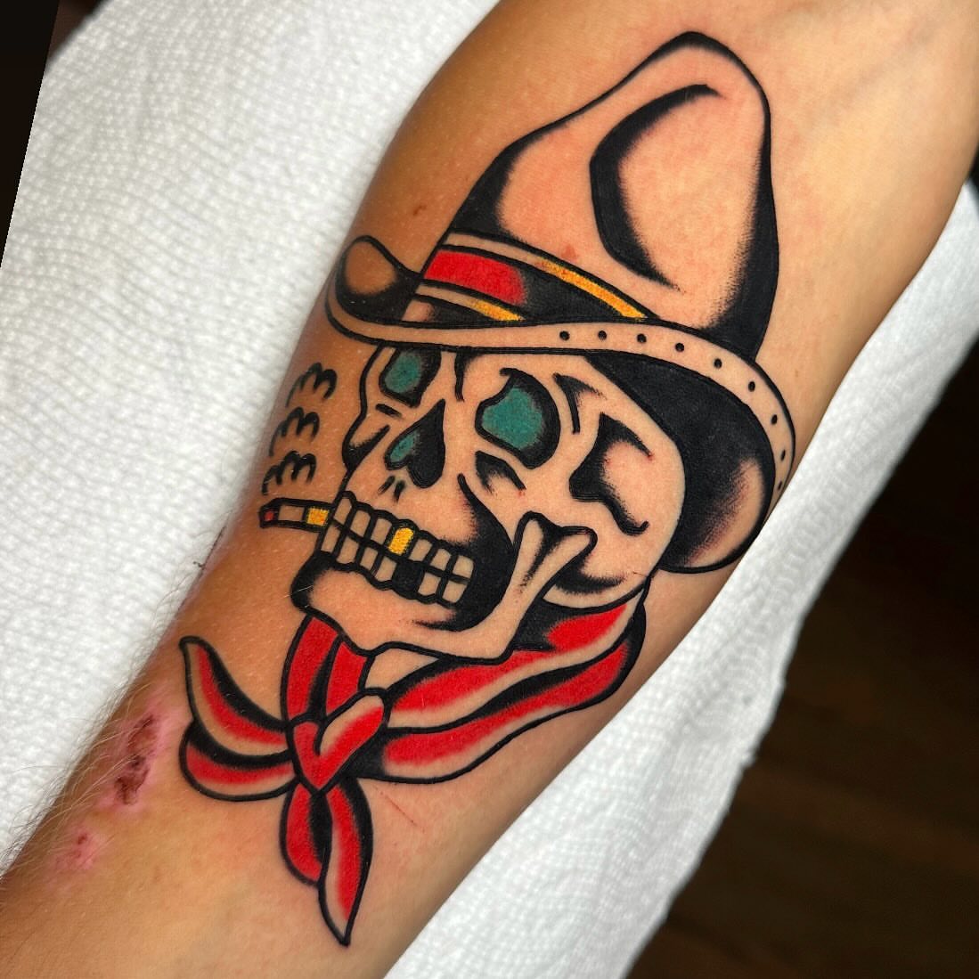 Skull wearing hat American traditional tattoo on the forearm by Mr. Brent