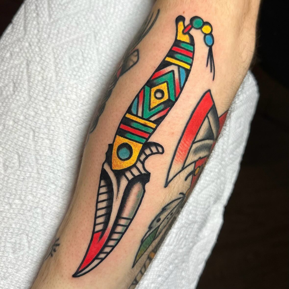 Knife American traditional tattoo on the forearm by Mr. Brent