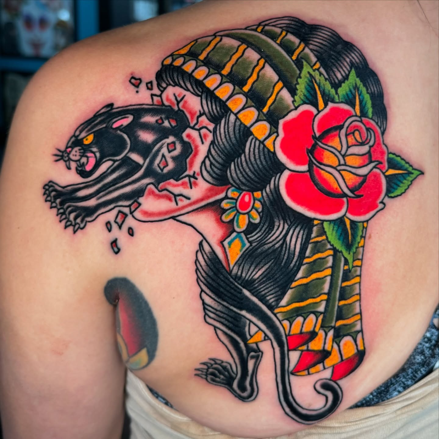 Panther and snake American traditional tattoo on the shoulder by Timothy Wood