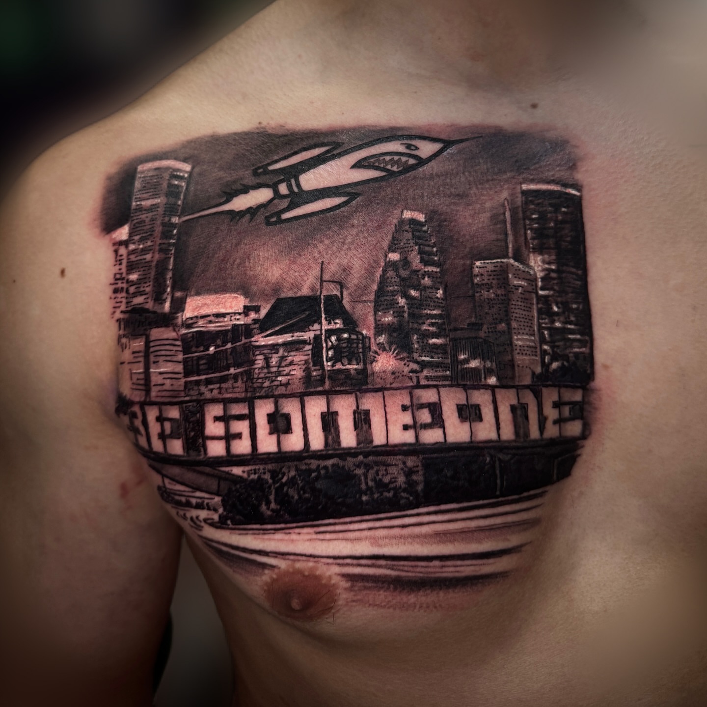 Cityscape with flying vehicle realism tattoo on the chest by Billy Harris