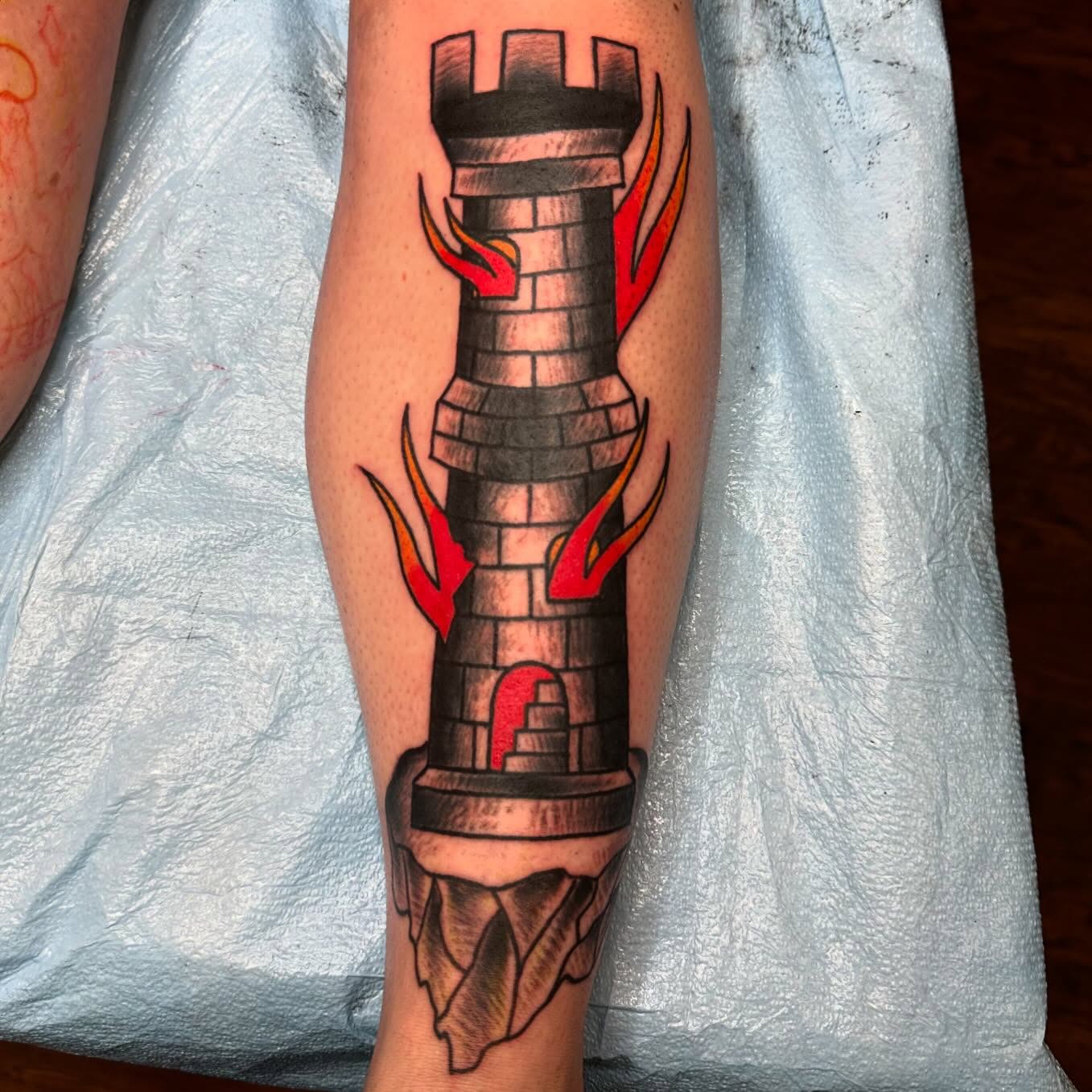 Castle tower American traditional tattoo on the forearm by Jackie