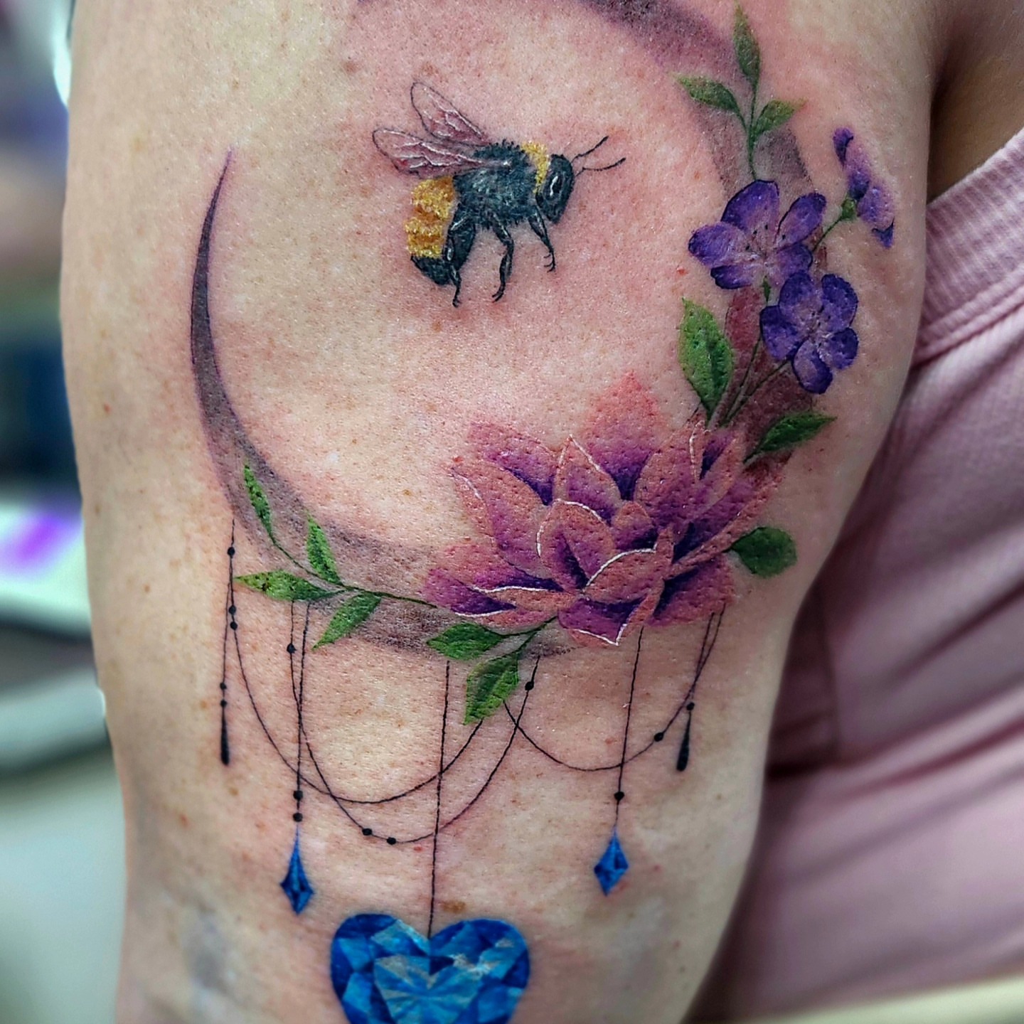 Bee and flowers realism tattoo on the forearm by Kayla Linton