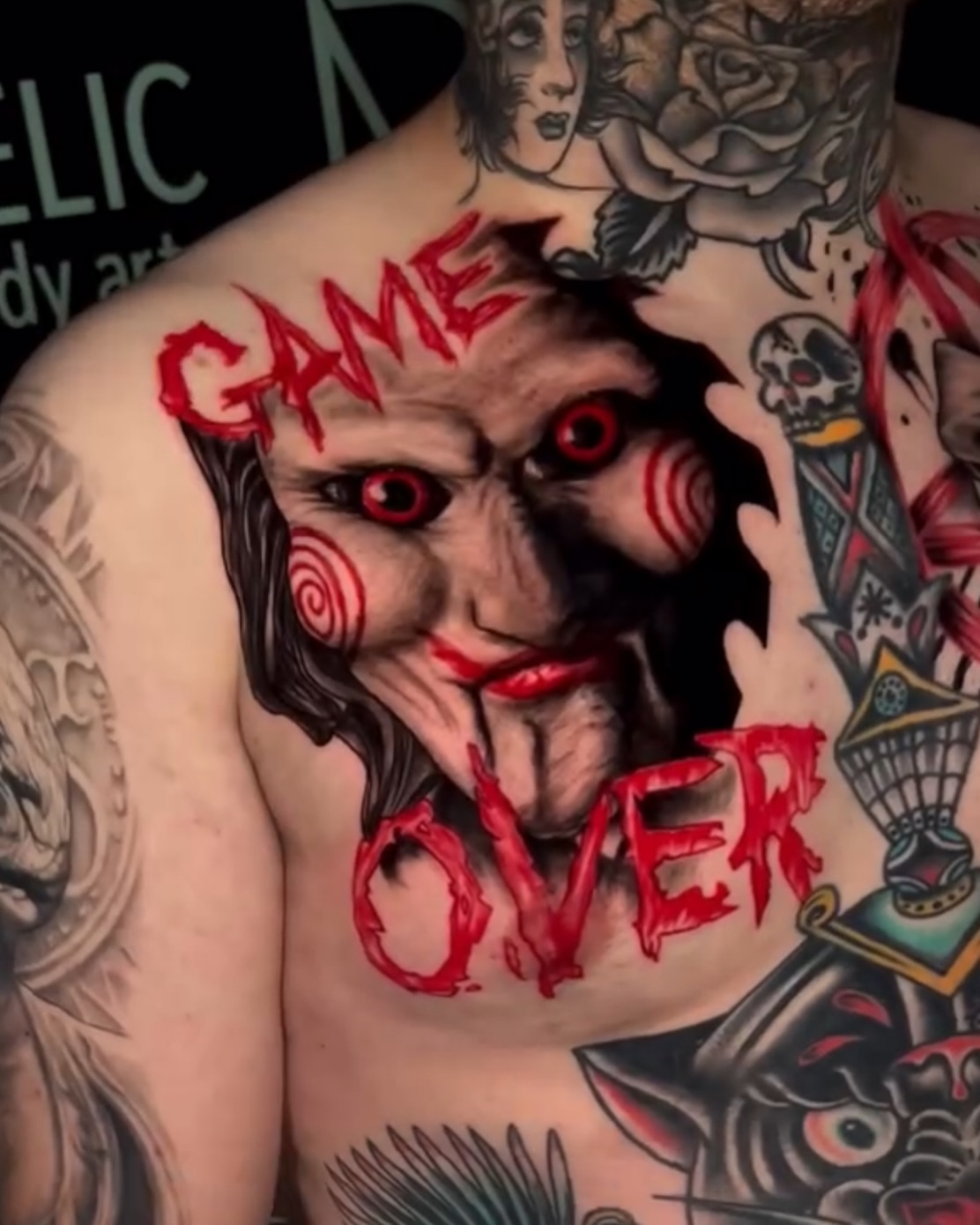 Jigsaw mask dark realism tattoo on the chest by 𝕭𝖗𝖞𝖈𝖊 𝖂𝖎𝖑𝖑𝖎𝖆𝖒