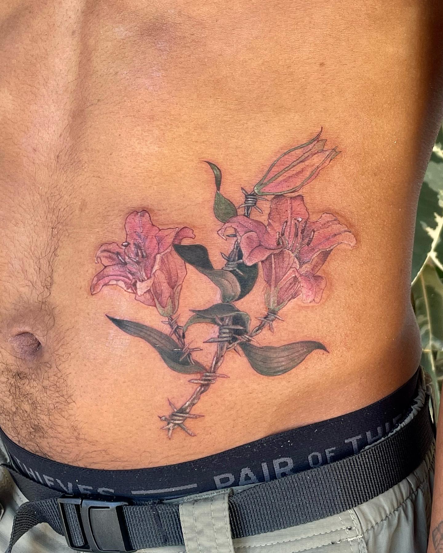 Flowers and barbed wire realism tattoo on the ribs by β±βΏβ° π π π° π πΎ β±βΏβ°