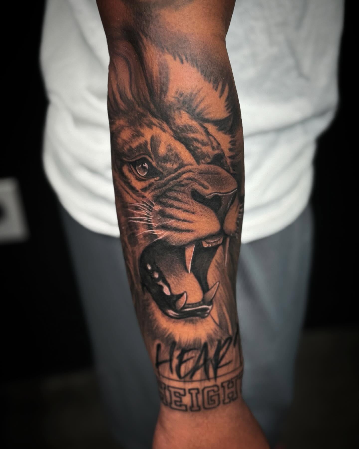 Lion realism tattoo on the forearm by Carlos Lujan