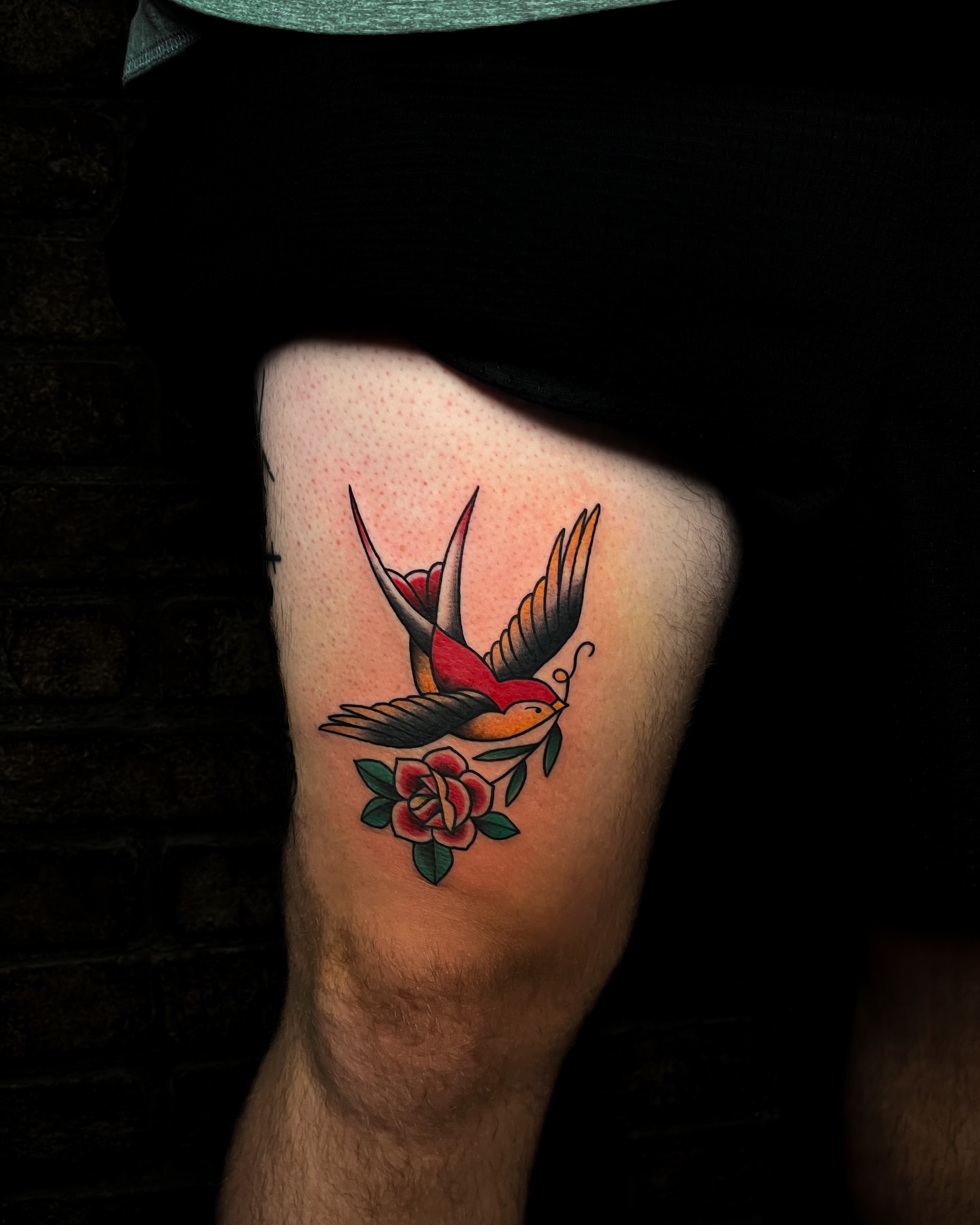 Bird and flower American traditional tattoo on the thigh by Demi DiMartino