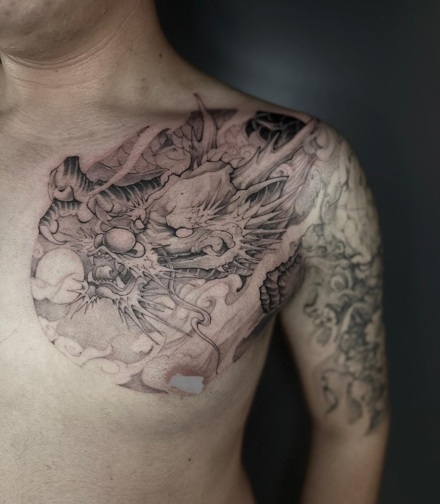 Dragon realism tattoo on the chest by Shihao zhao