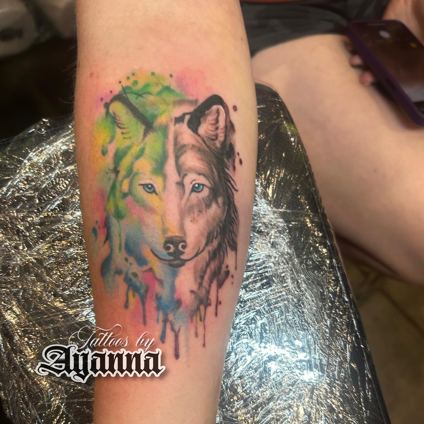 Wolf watercolor tattoo on the forearm by Ayanna Luna