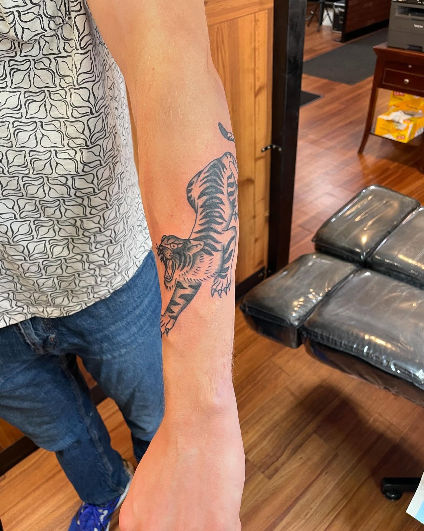 Tiger black and grey tattoo on the forearm by Anna sabrowsky