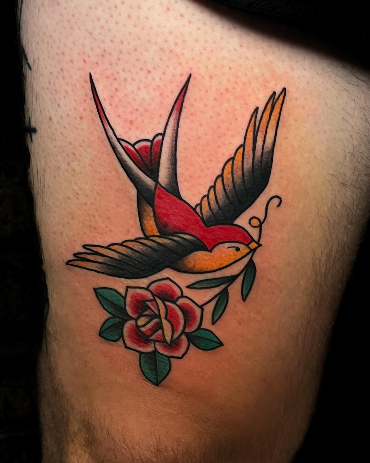 Swallow and rose American traditional tattoo on the thigh by Demi DiMartino