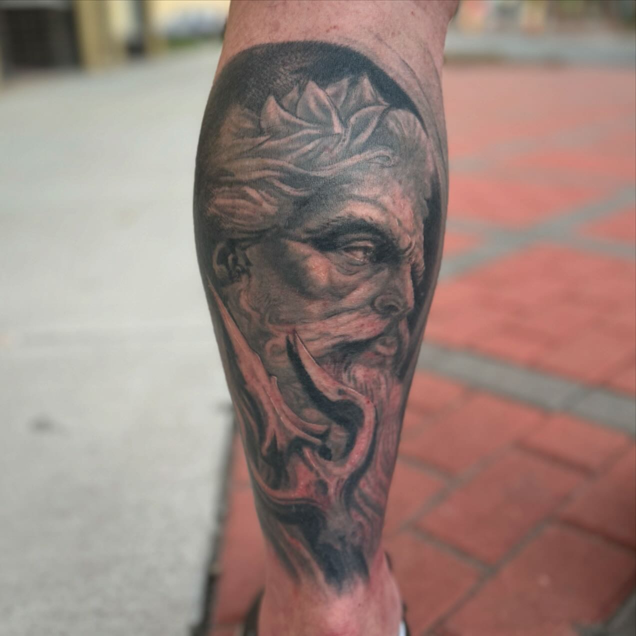 Man's face realism tattoo on the forearm by Kyle J. Bishop