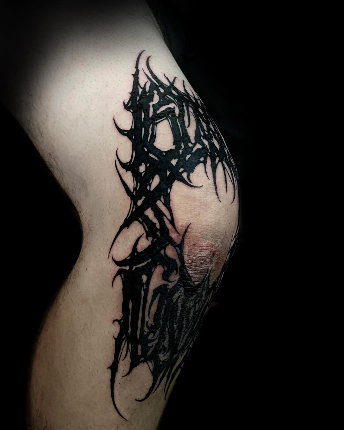 Abstract tribal tattoo on the thigh by Nathan