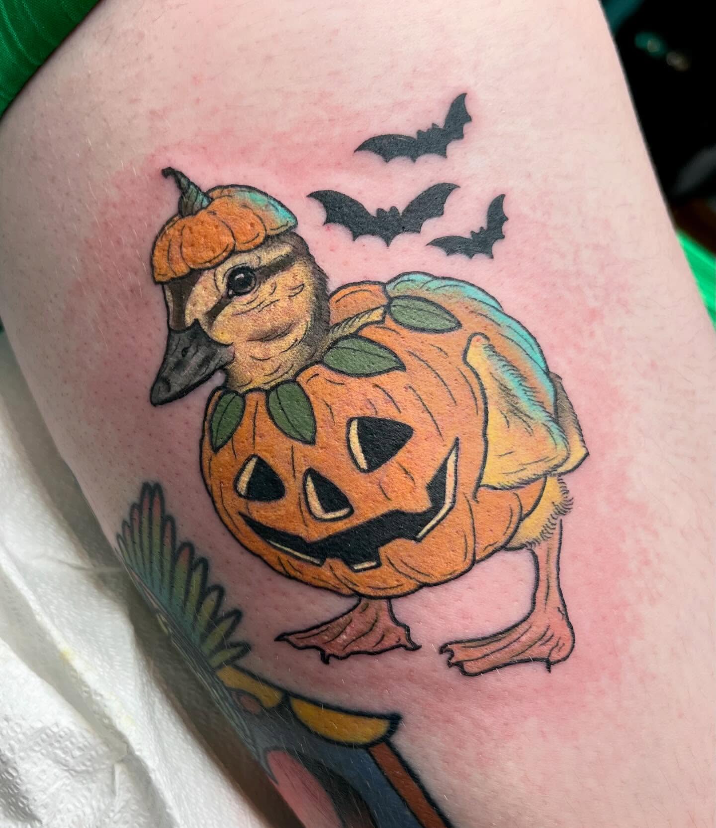 Duck in pumpkin American traditional tattoo on the thigh by Caitlin Stairs