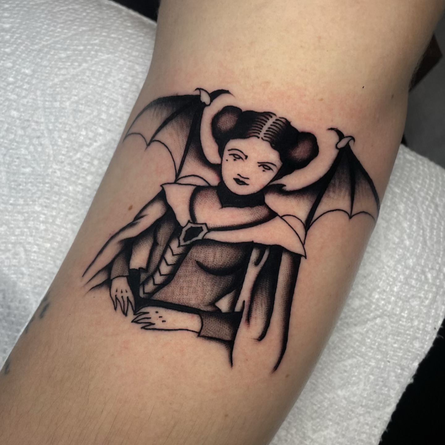 Winged woman black and grey tattoo on the forearm by Toulouse Noble, Portland, Oregon