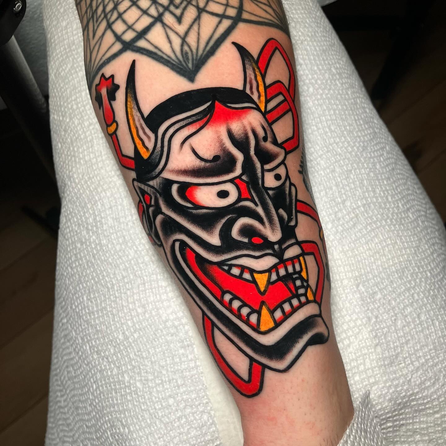Demon mask American traditional tattoo on the forearm by John Lemon