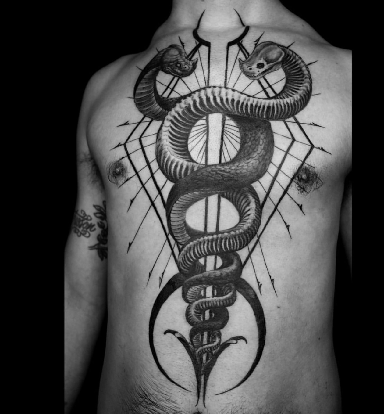 Caduceus geometric tattoo on the chest by ➕d U S T I N C H A R L e S➕, Seattle, Washington