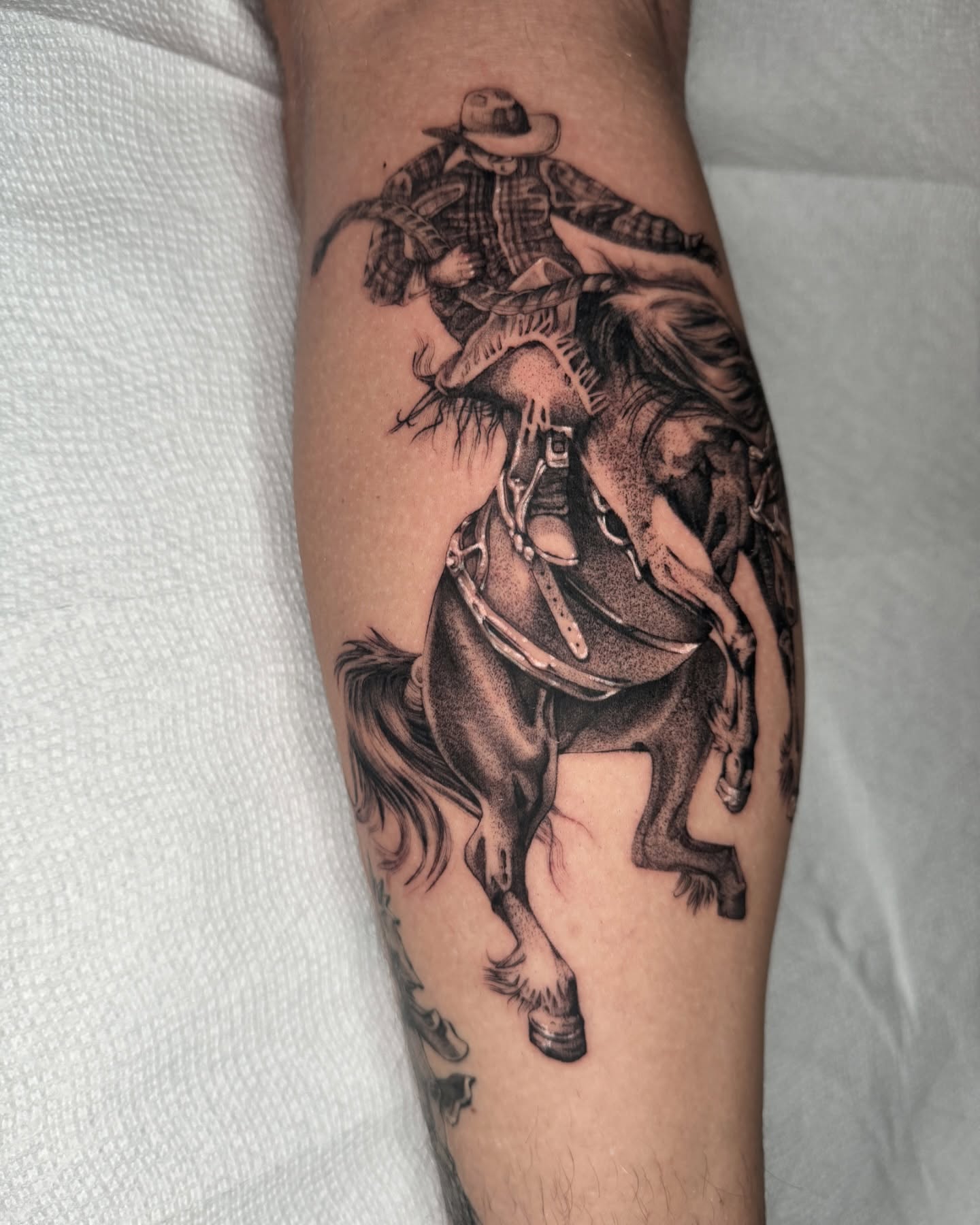 Cowboy riding horse realism tattoo on the forearm by ella