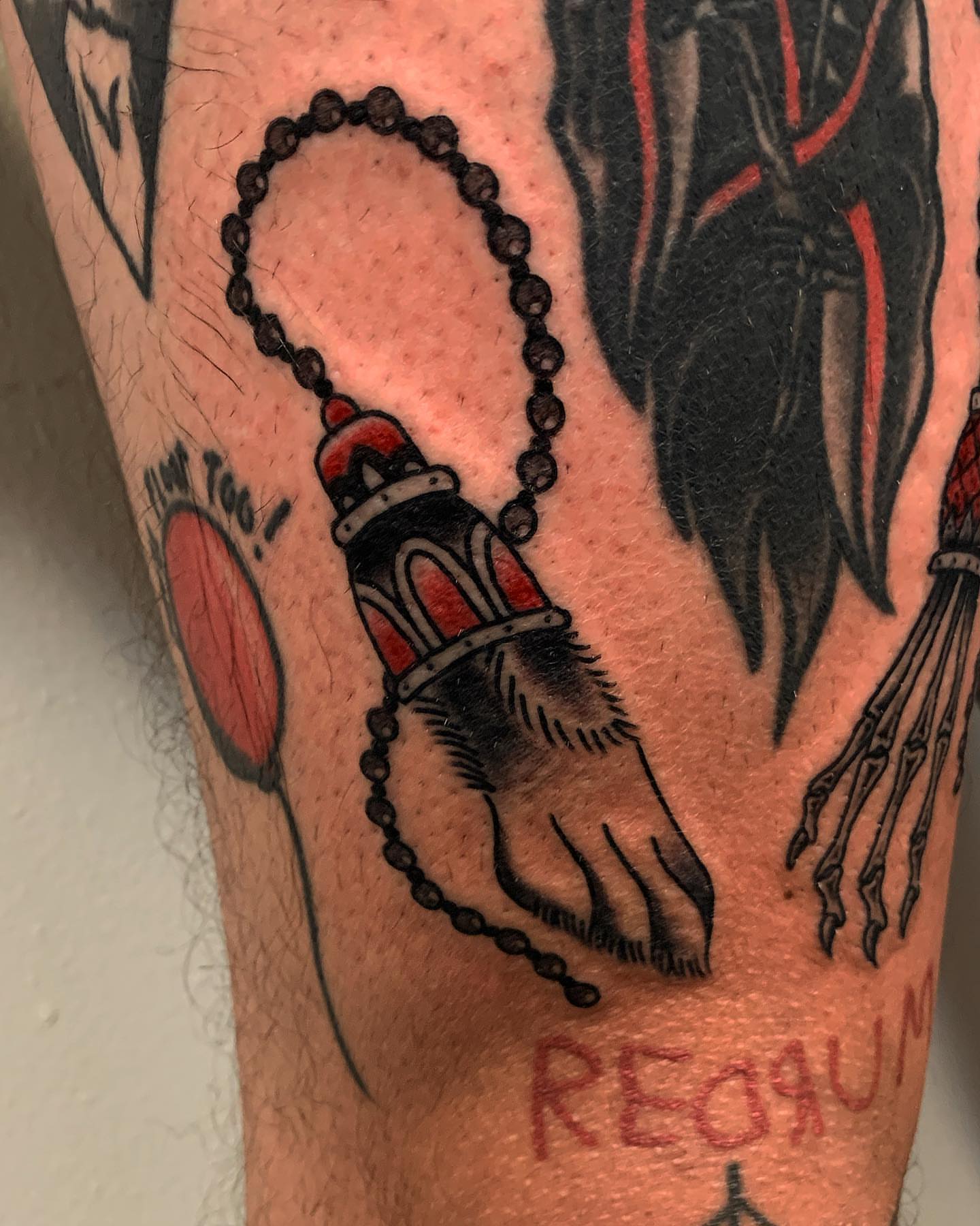 Rosary American traditional tattoo on the forearm by Brii Moser