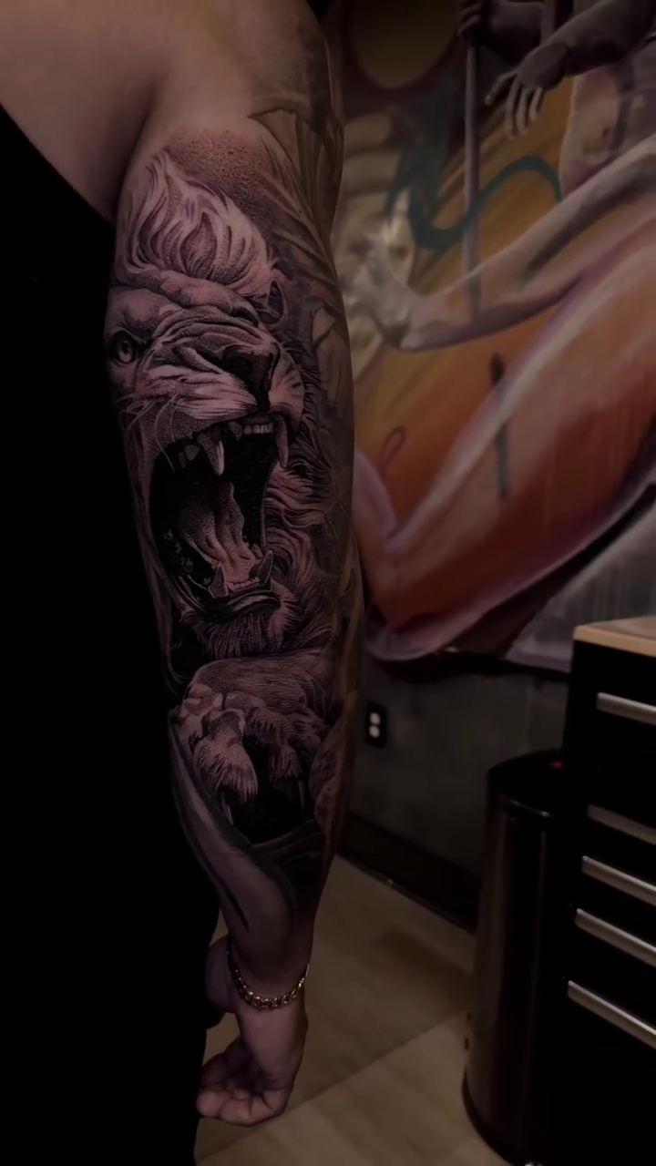 Lion and cub realism tattoo by Ana Fajardo