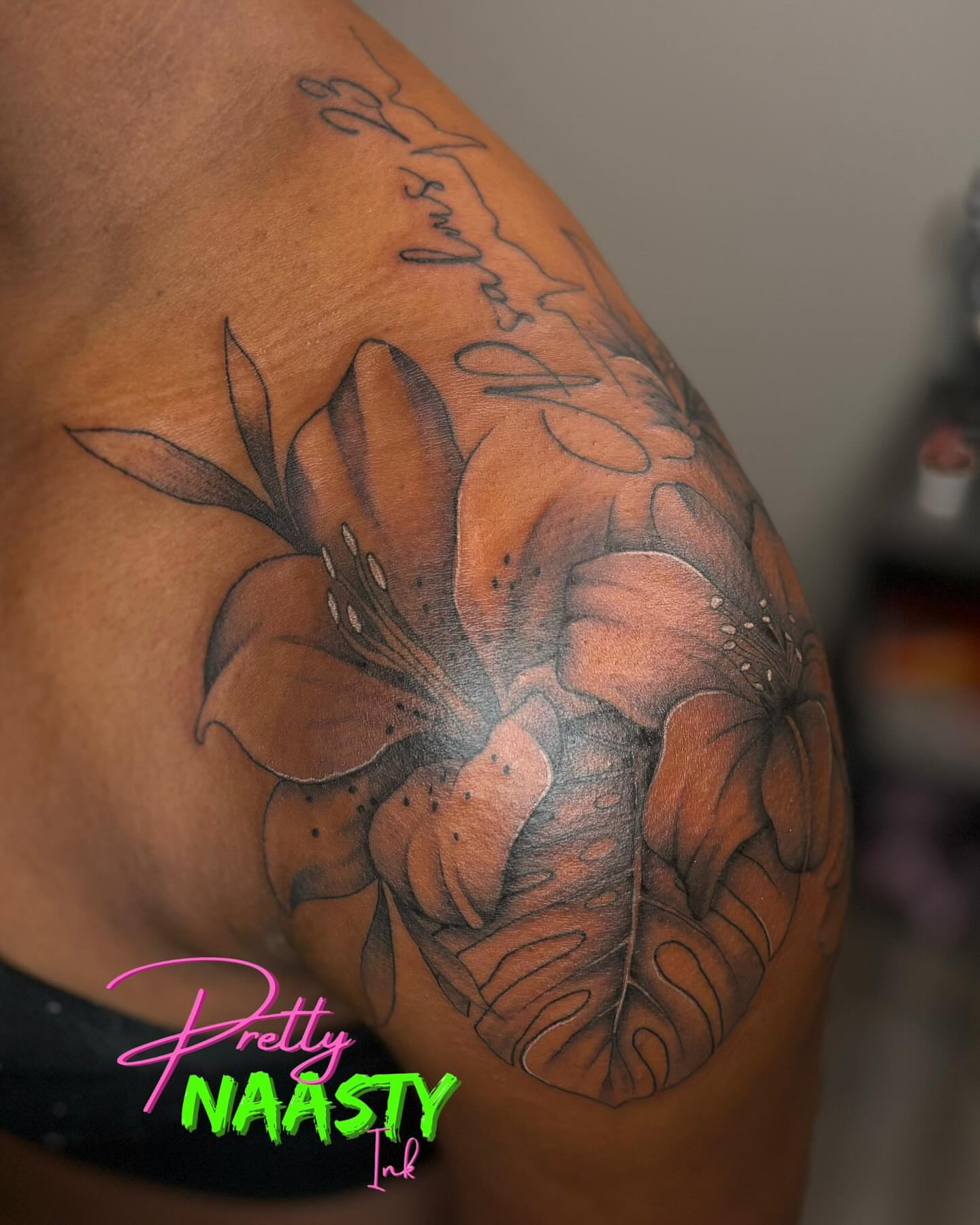 Lilies and butterfly black and grey tattoo on the shoulder by Pretty Naasty Ink🖤