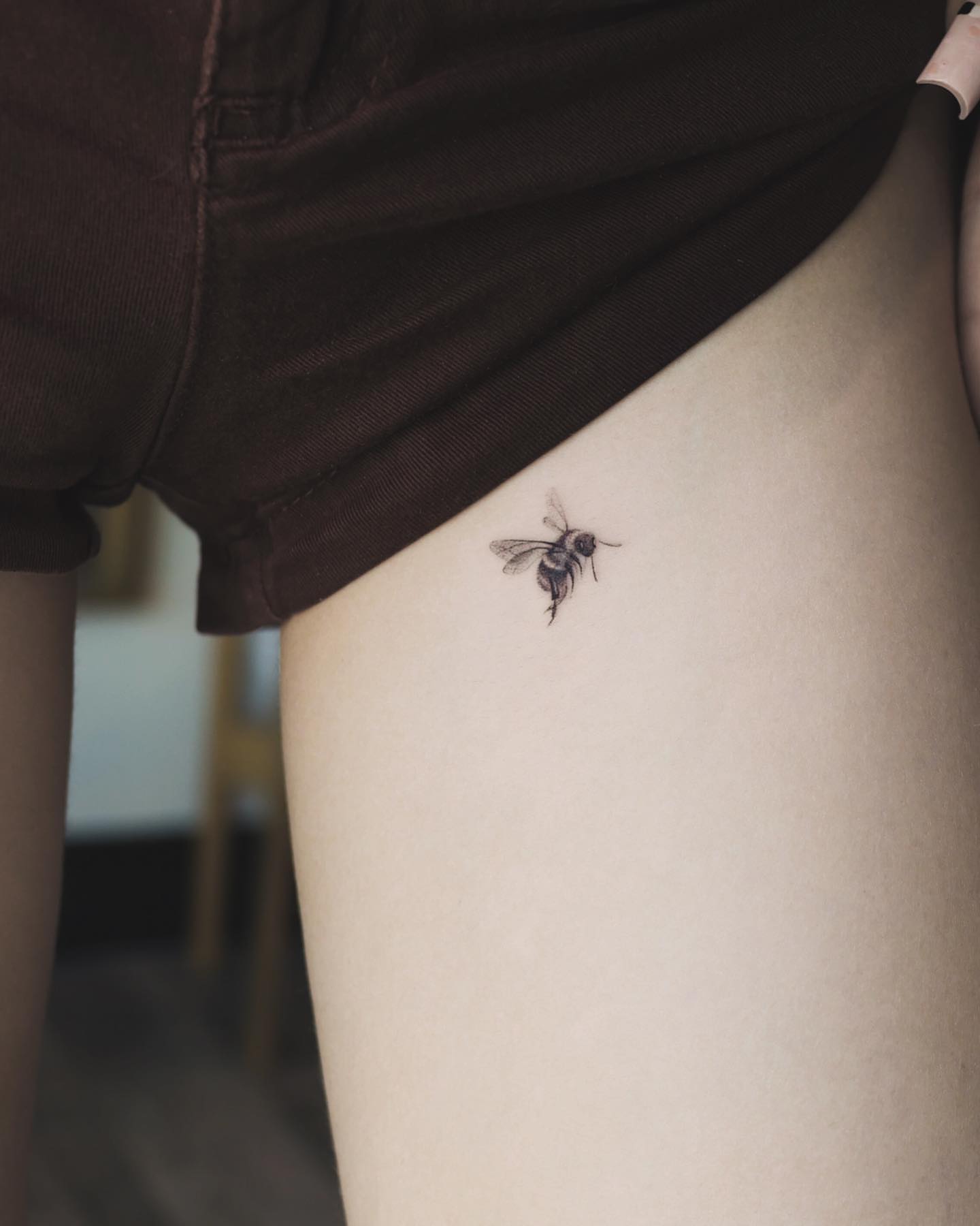 Bee black and grey tattoo on the thigh by Beans