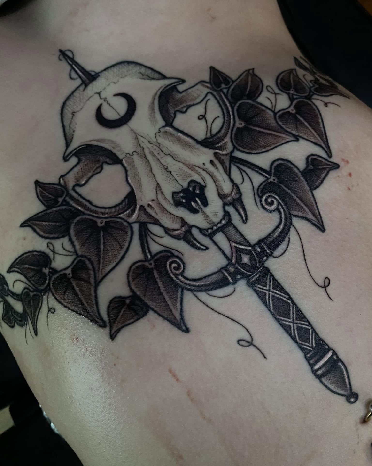 Skull and dagger dark realism tattoo on the chest by 𝔗𝔞𝔶𝔩𝔬𝔯 𝔈𝔩𝔦𝔷𝔞𝔟𝔢𝔱𝔥, Tulsa, Oklahoma