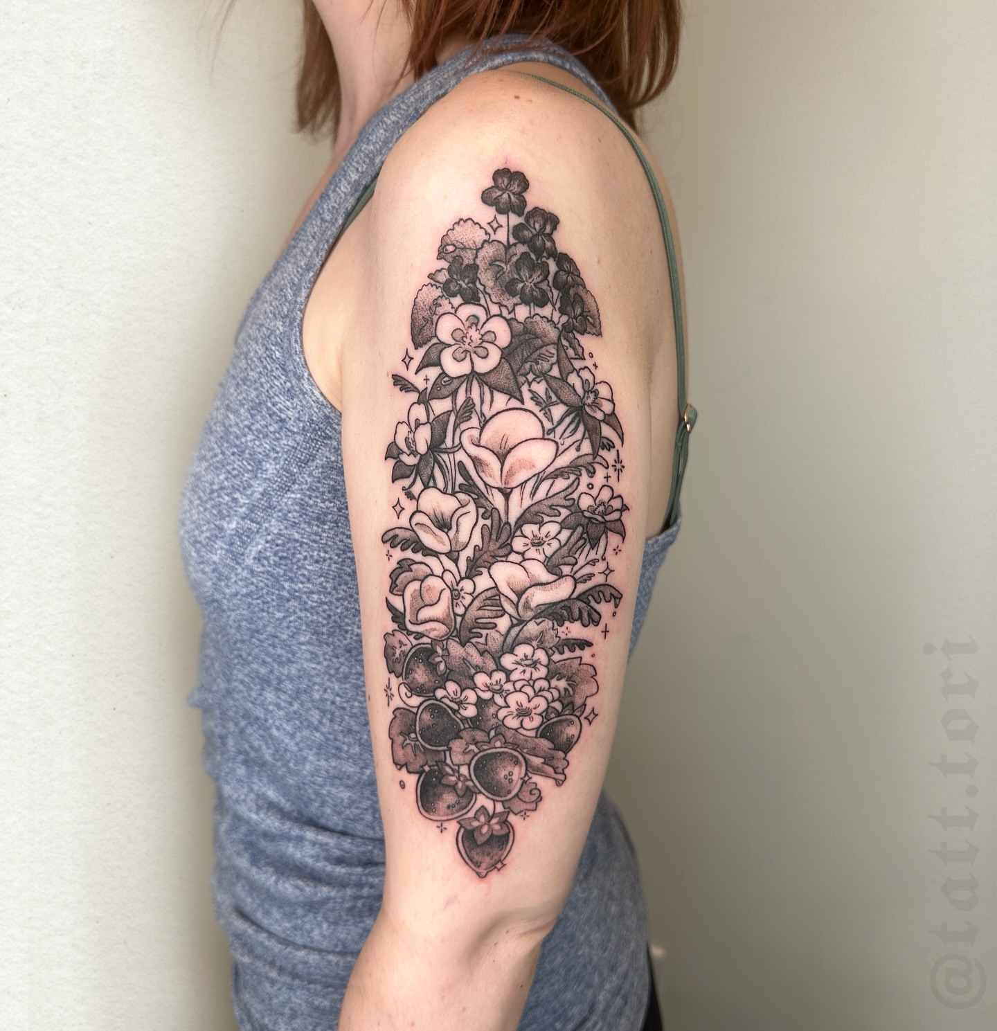 Floral bouquet black and grey tattoo on the upper arm by 𝔱𝔬𝔯𝔦