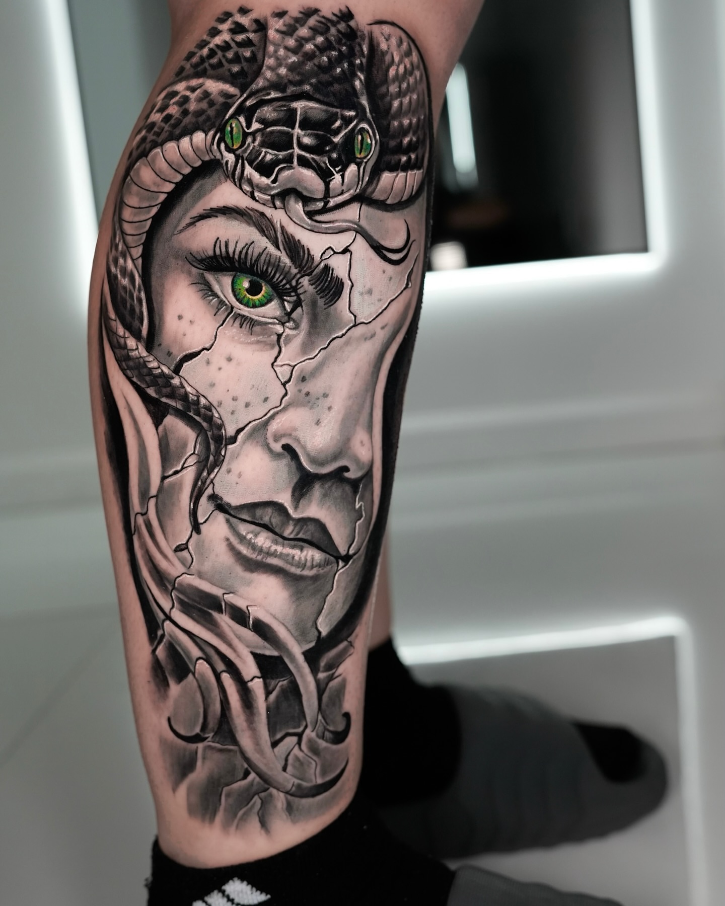 Snake and woman's face realism tattoo on the forearm by Gabriel Garcia