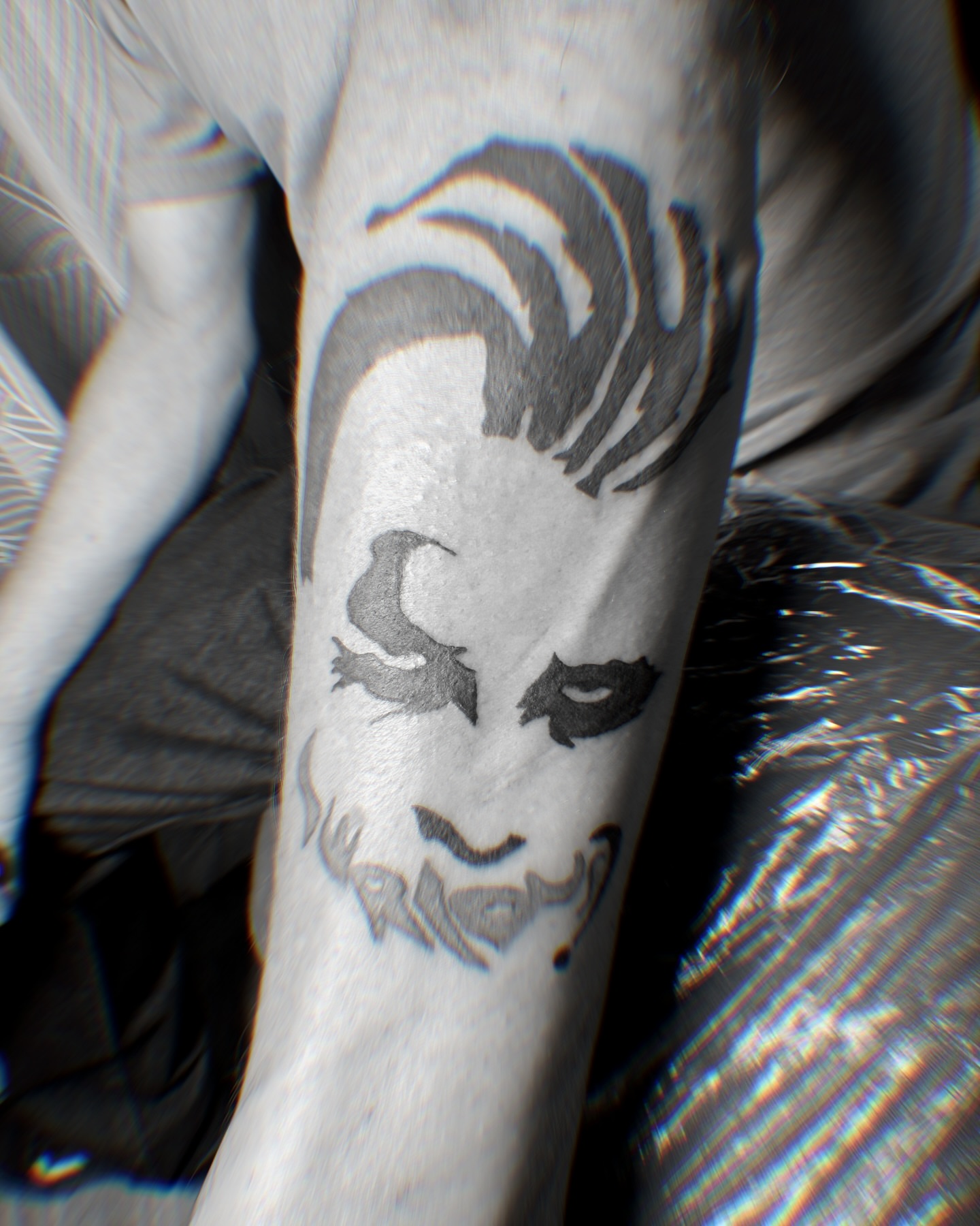 Joker face black and grey tattoo on the forearm by Tattoo Artist ⚔️ San Diego, CA