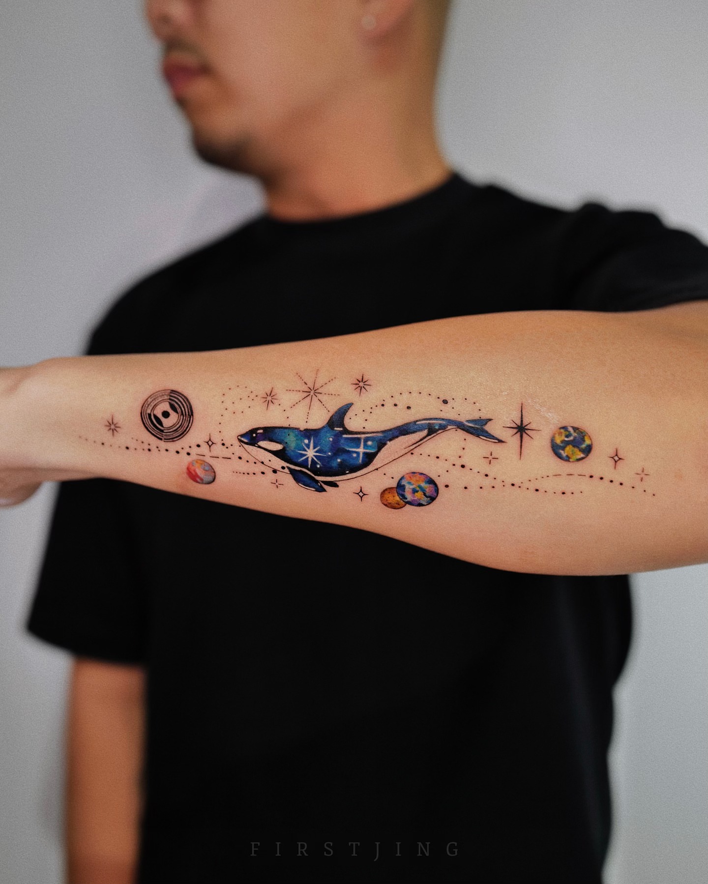Whale and planets dotwork tattoo on the forearm by Seattle
