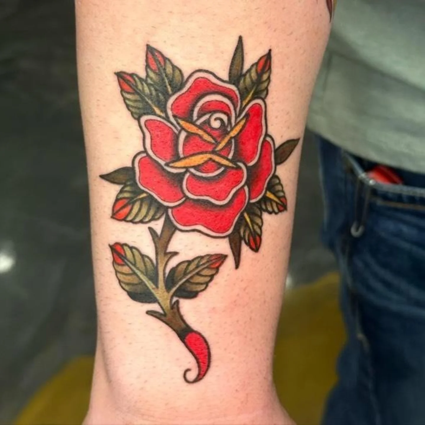 Red rose American traditional tattoo on the forearm by Christopher Heffley
