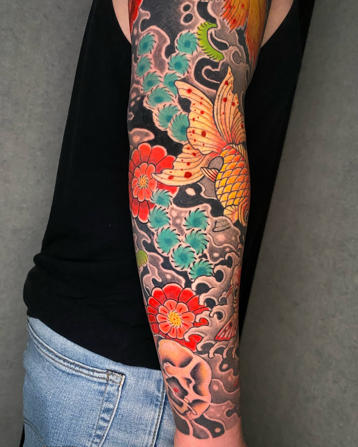Koi fish and floral japanese irezumi tattoo on the forearm by Mitch Bonifay