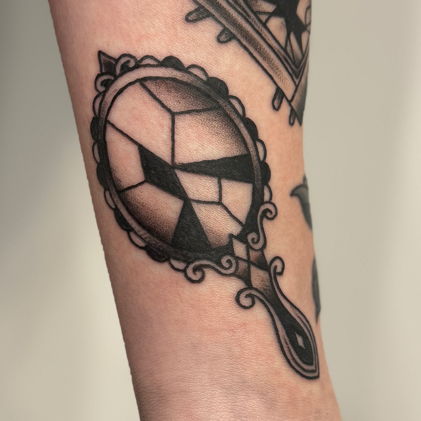 Soccer ball black and grey tattoo on the forearm by Ashley Rose - Minnesota Tattoo Artist