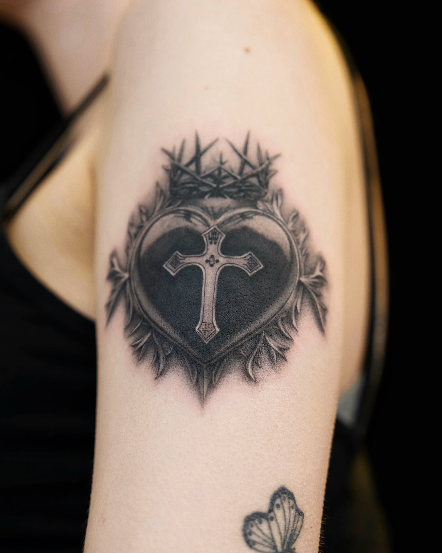 Heart with cross realism tattoo on the forearm by Gen Li