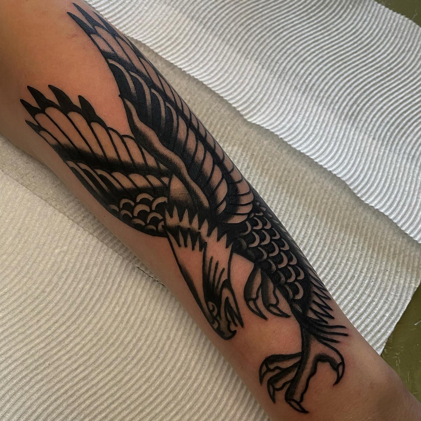 Bird black and grey tattoo on the forearm by Erin Chambers