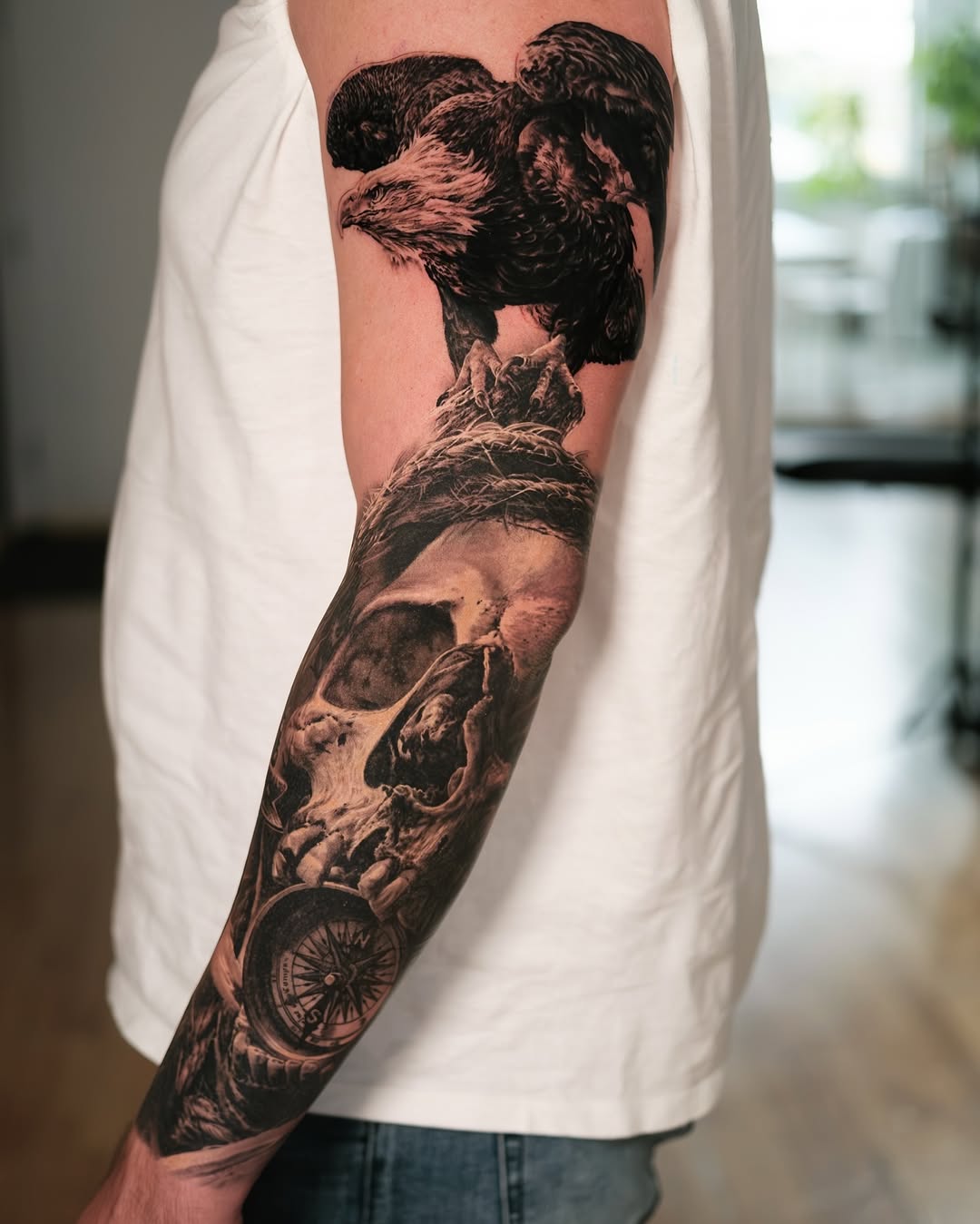 Eagle and skull with compass realism tattoo on the forearm by Christopher Powell