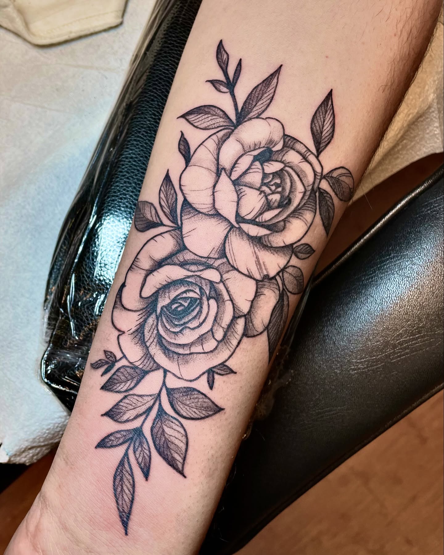 Roses black and grey tattoo on the forearm by Tattoo Artist