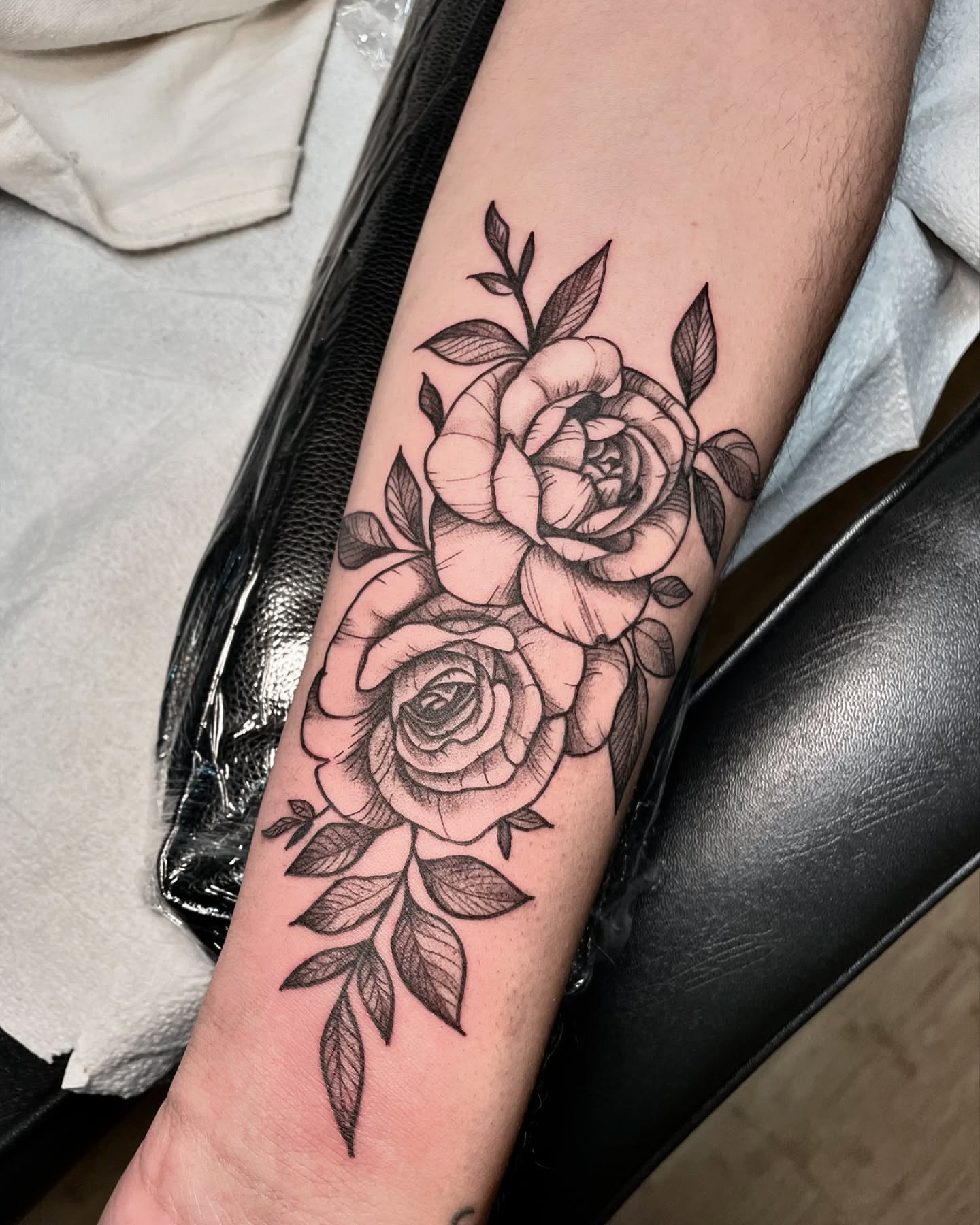 Roses black and grey tattoo on the forearm by Tattoo Artist