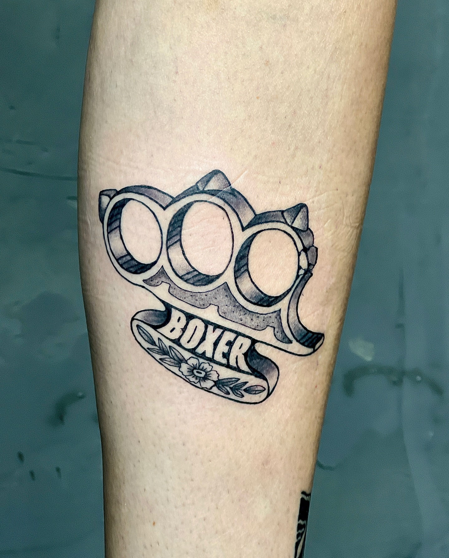 Boxing gloves black and grey tattoo on the forearm by Rebel milly Tattoo