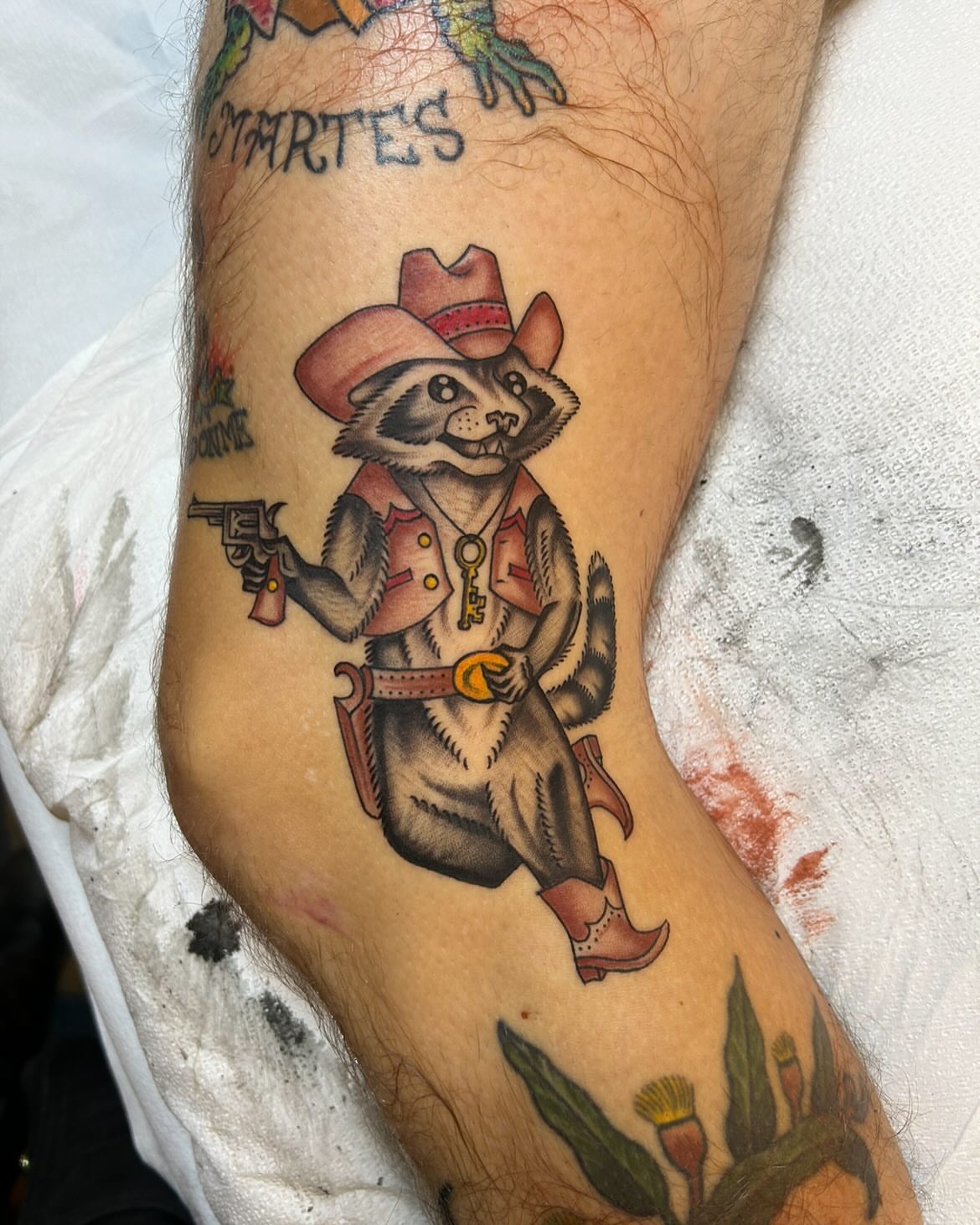 Raccoon cowboy American traditional tattoo on the forearm by Sam Perry, Denver, Colorado