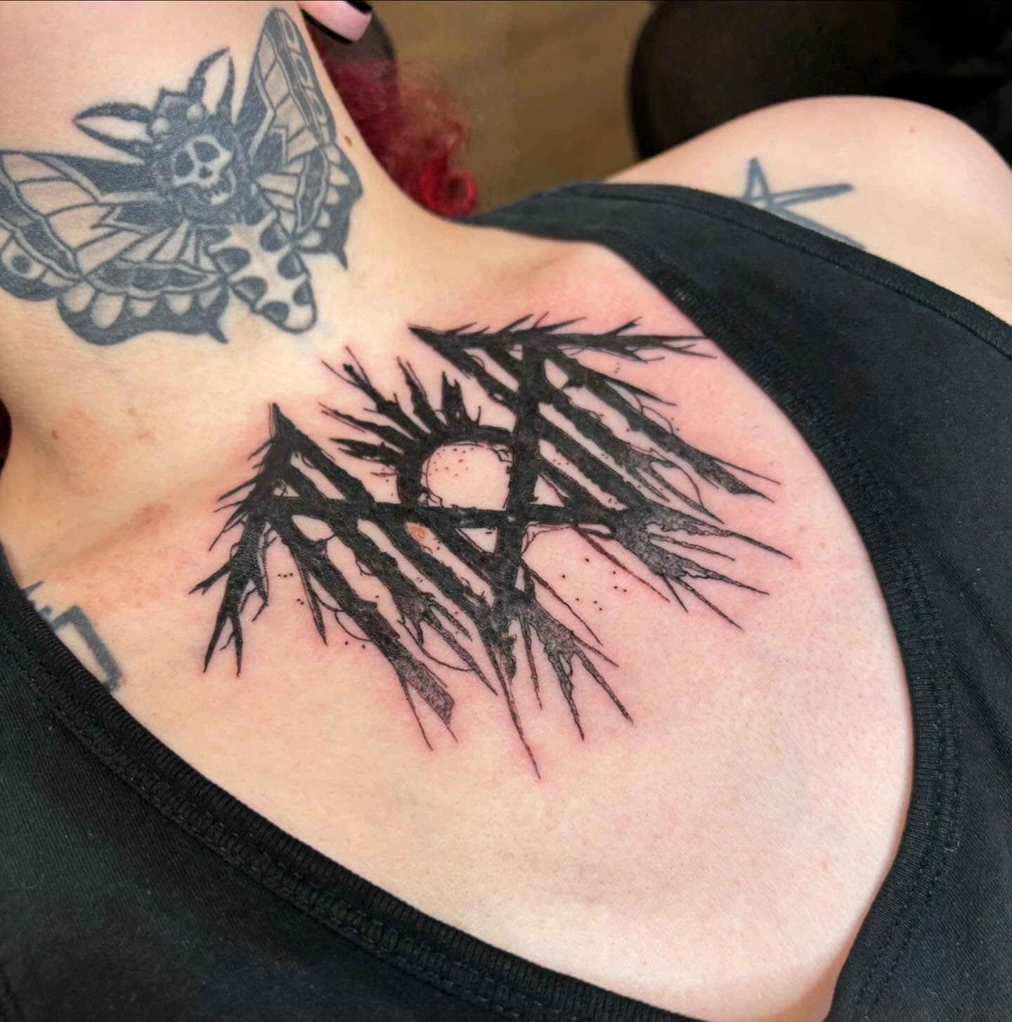 Pentagram black and grey tattoo on the chest by Bryan Black