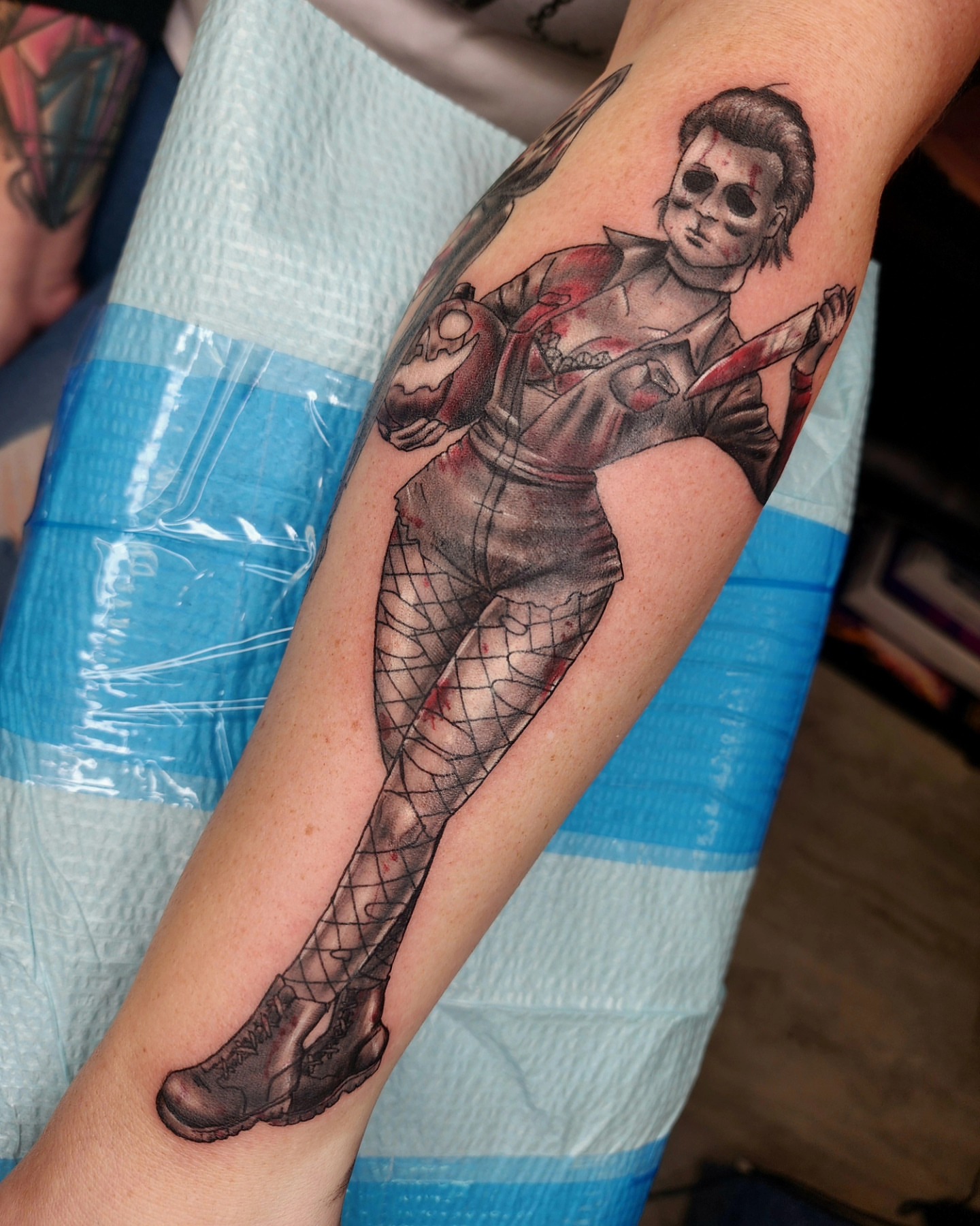Woman with knife realism tattoo on the forearm by Zach Mullins