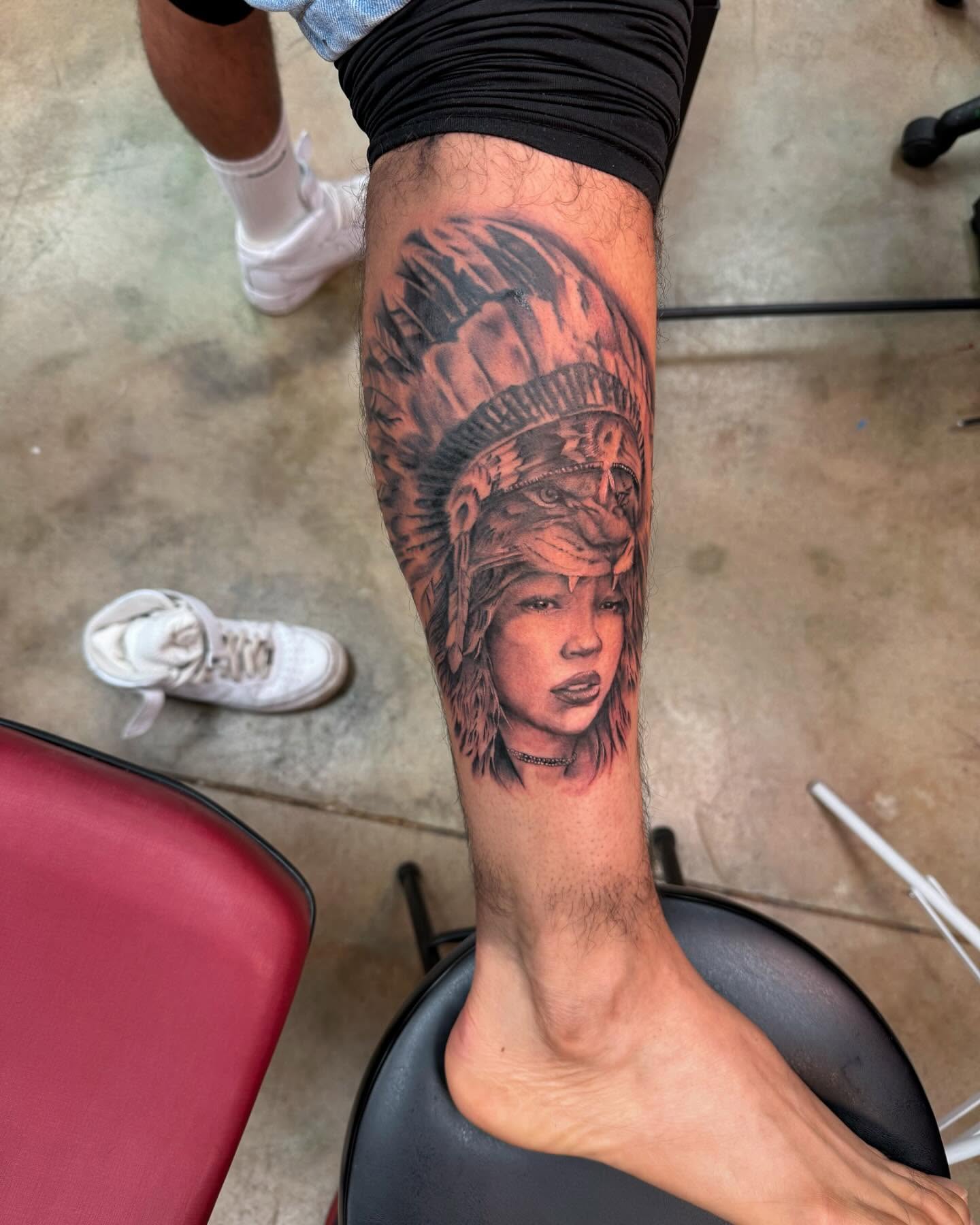 Indian headdress realism tattoo on the forearm by Shawn Cook