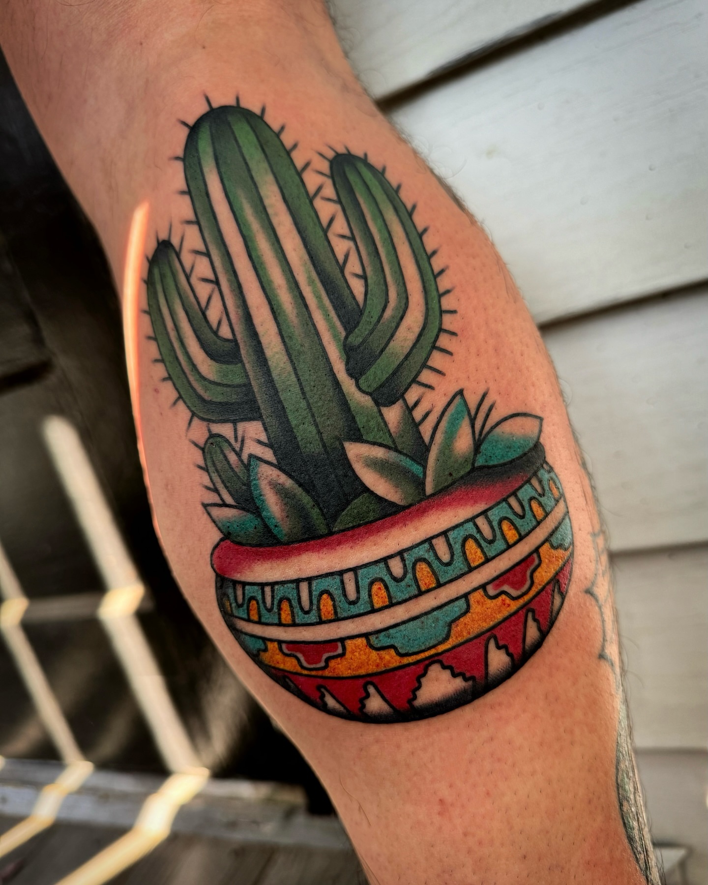 Cactus in pot American traditional tattoo on the thigh by Daniel Mesen