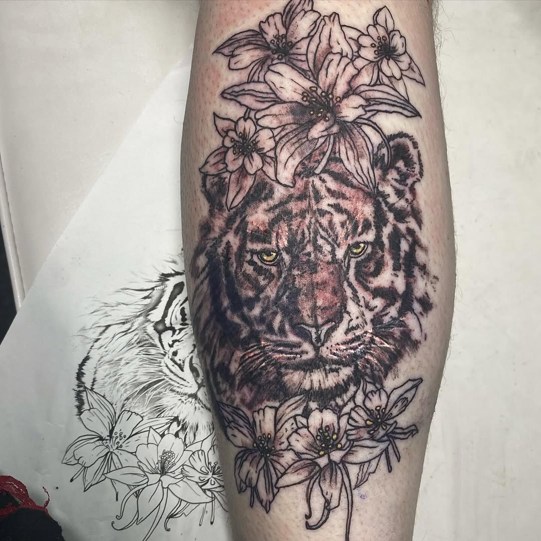 Tiger head with flowers realism tattoo on the forearm by MD Ariel🦷